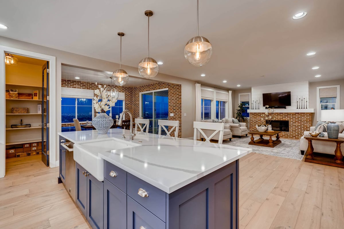 Bright kitchen with white cabinets and island in a custom home by Sheffield Homes at 6694 Balsam Street, Arvada, CO