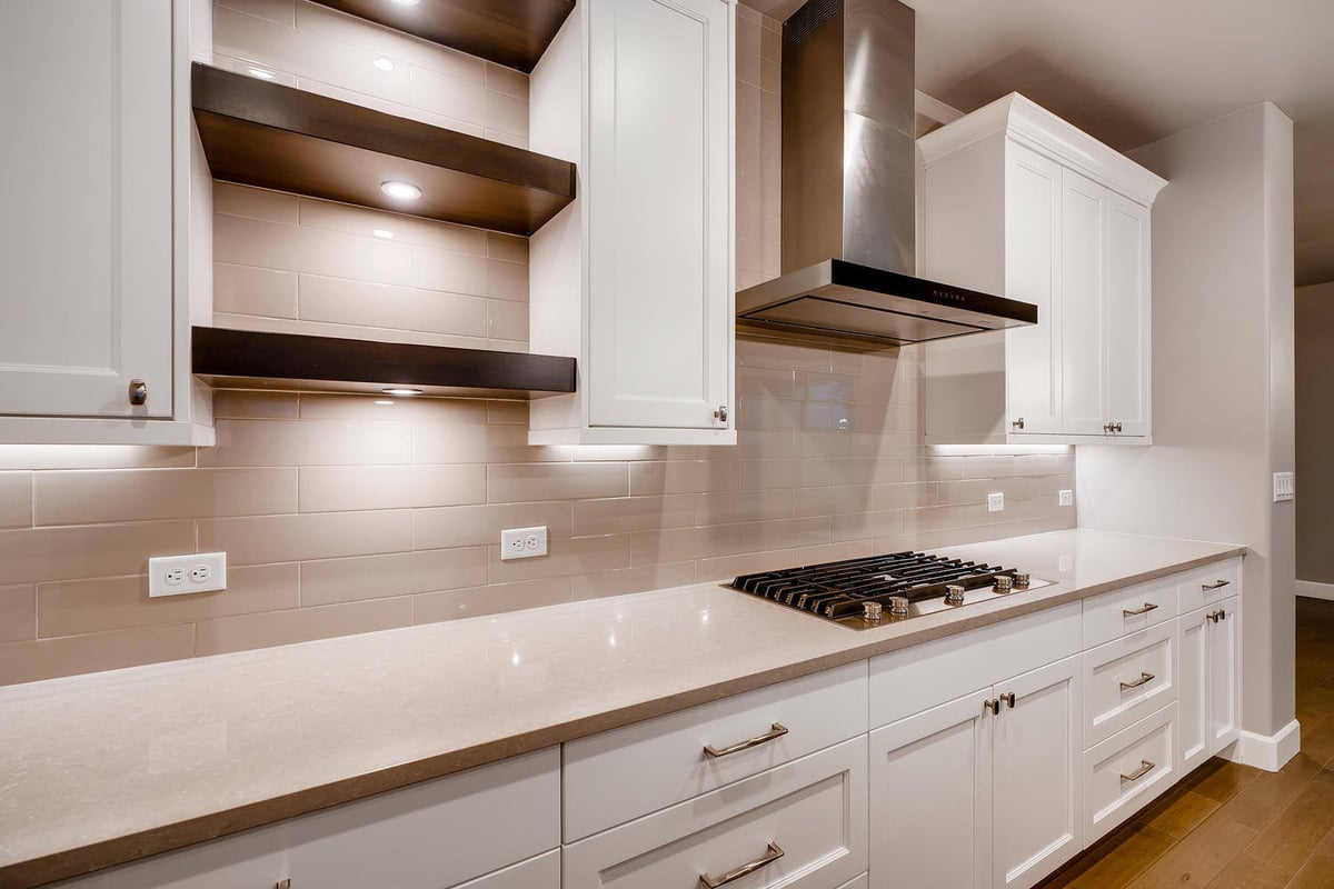 Gourmet kitchen with granite island and stainless steel appliances in a custom home by Sheffield Homes in Arvada, CO