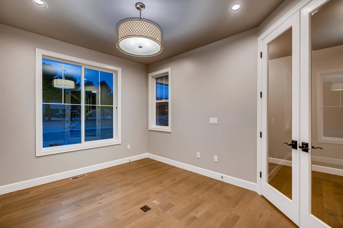 Home office with glass French doors in a custom home by Sheffield Homes in Arvada, CO