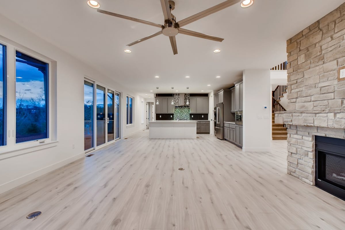 Custom living room in Arvada, CO home by Sheffield Homes, with a ceiling fan and open layout