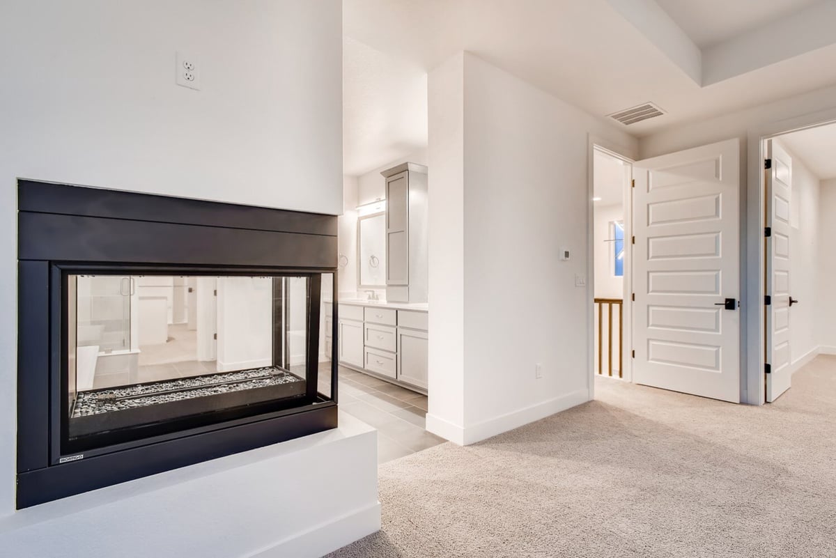 Detail of a modern fireplace in the primary suite of an Arvada, CO home