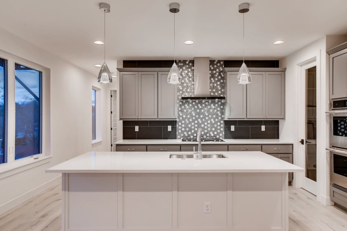 Gray kitchen with mosaic backsplash in a Sheffield Homes custom home, Arvada, CO