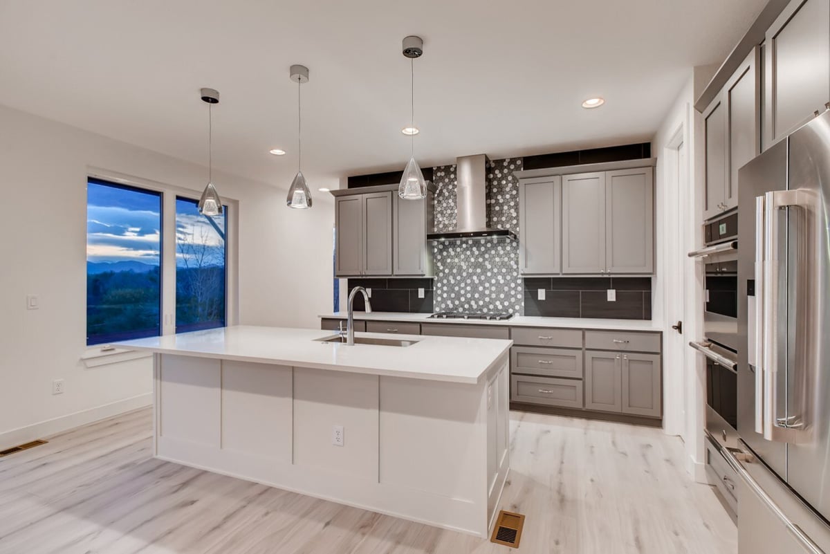 Kitchen with gray cabinetry and modern lighting in a Sheffield Homes custom home, Arvada, CO