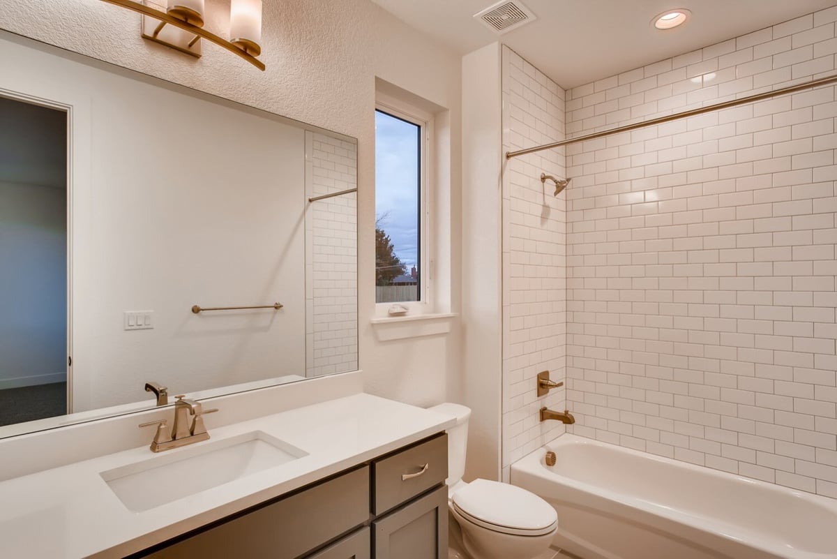Modern bathroom with subway tile shower and sleek vanity in Arvada, CO home