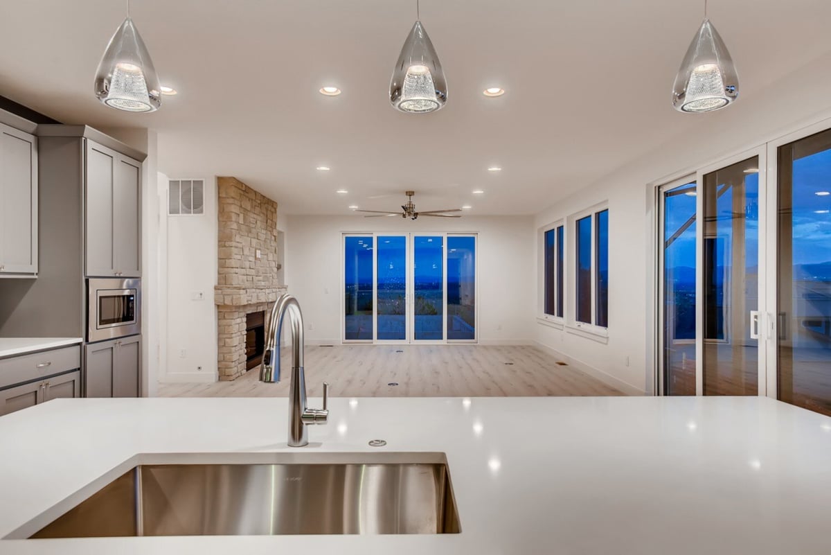 Modern kitchen and living area with a large island and view of the mountains in Arvada, CO