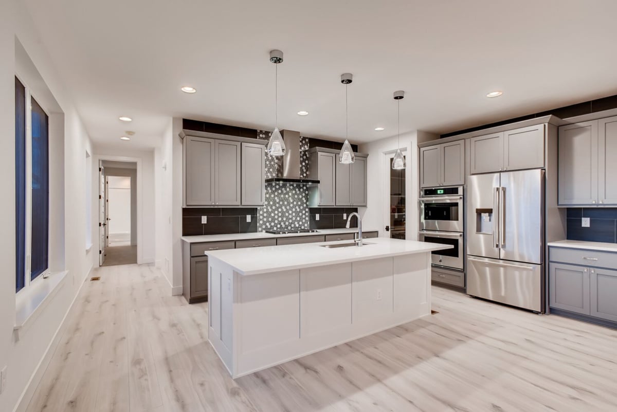 Modern kitchen with gray cabinetry and island in a Sheffield Homes custom home, Arvada, CO