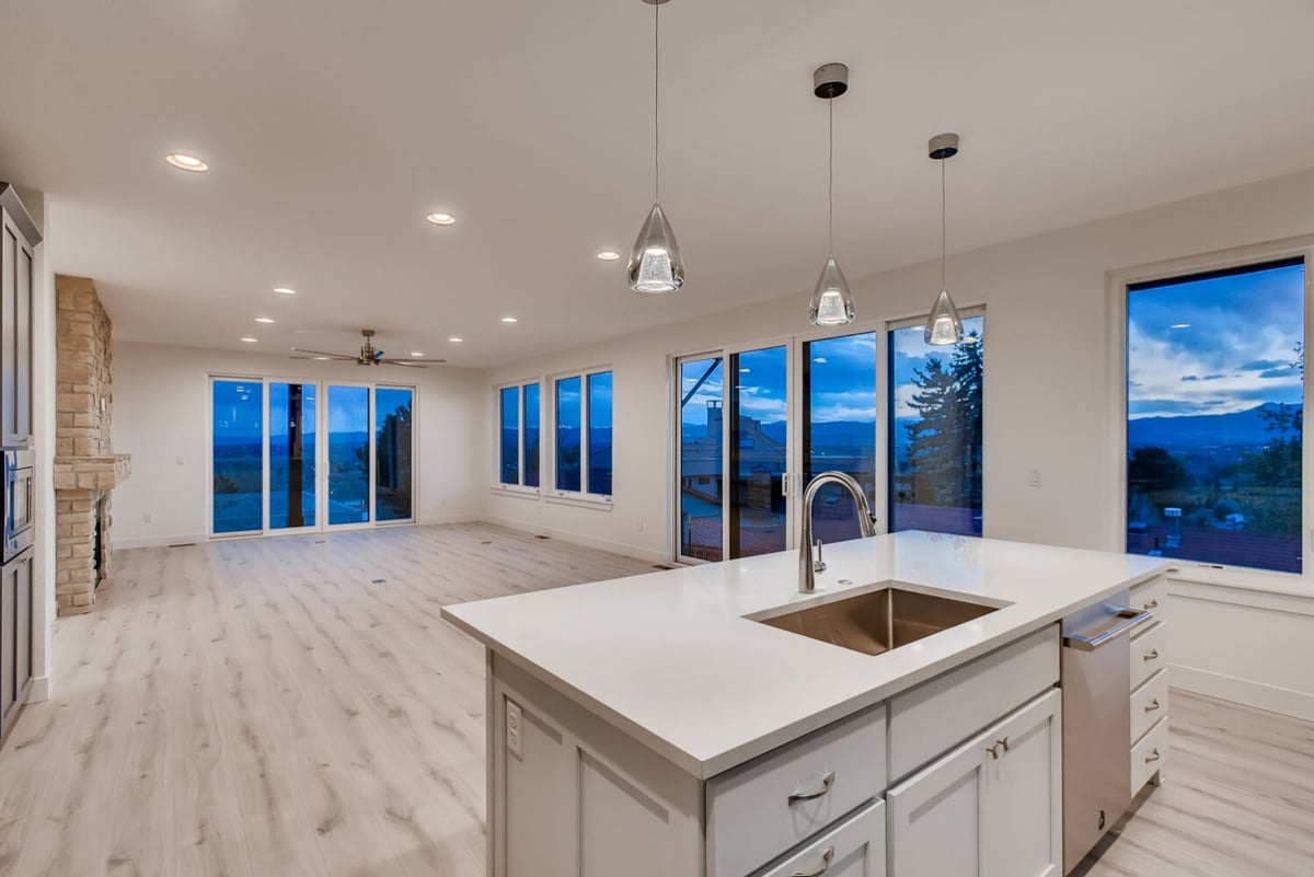 Open kitchen layout with island and living room view in a Sheffield Homes custom home, Arvada, CO