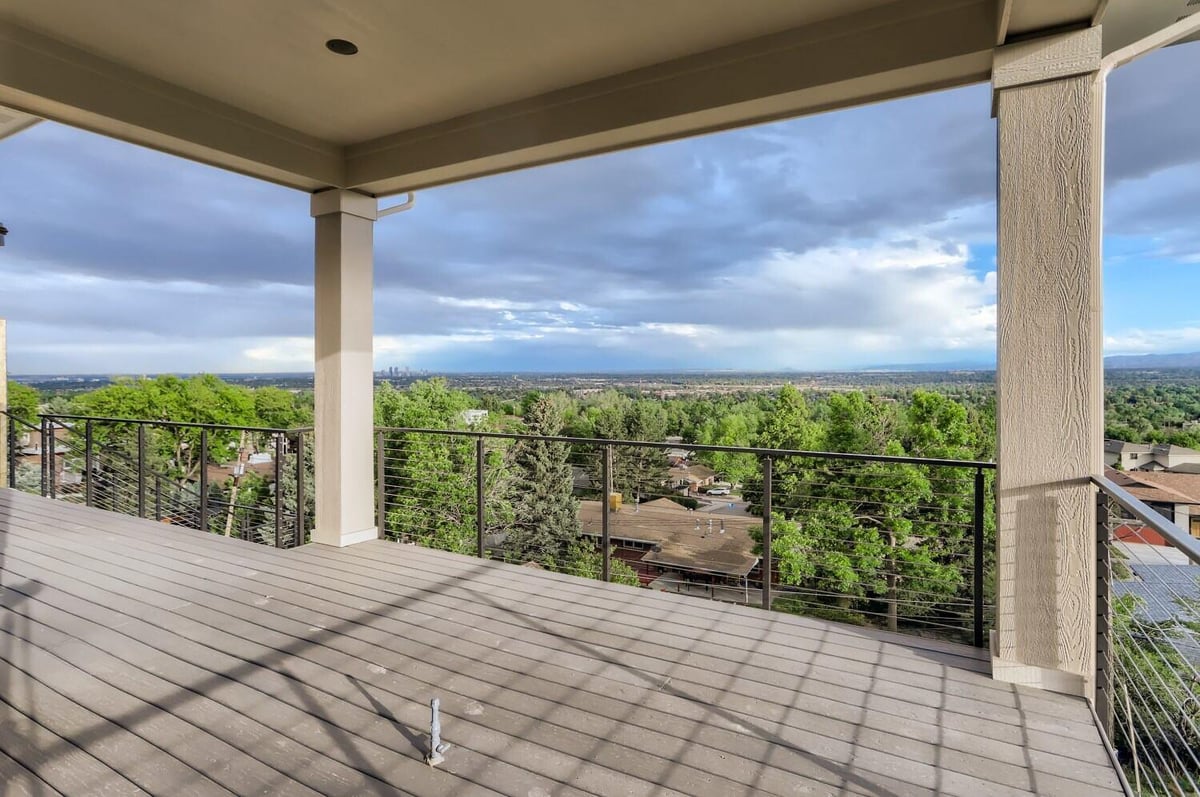 Deck with expansive views of the surrounding landscape in a custom home by Sheffield Homes in Arvada, CO