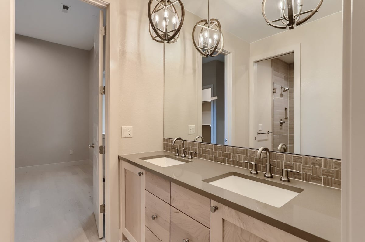 Lower level bathroom with modern fixtures and clean design by Sheffield Homes in Arvada, CO