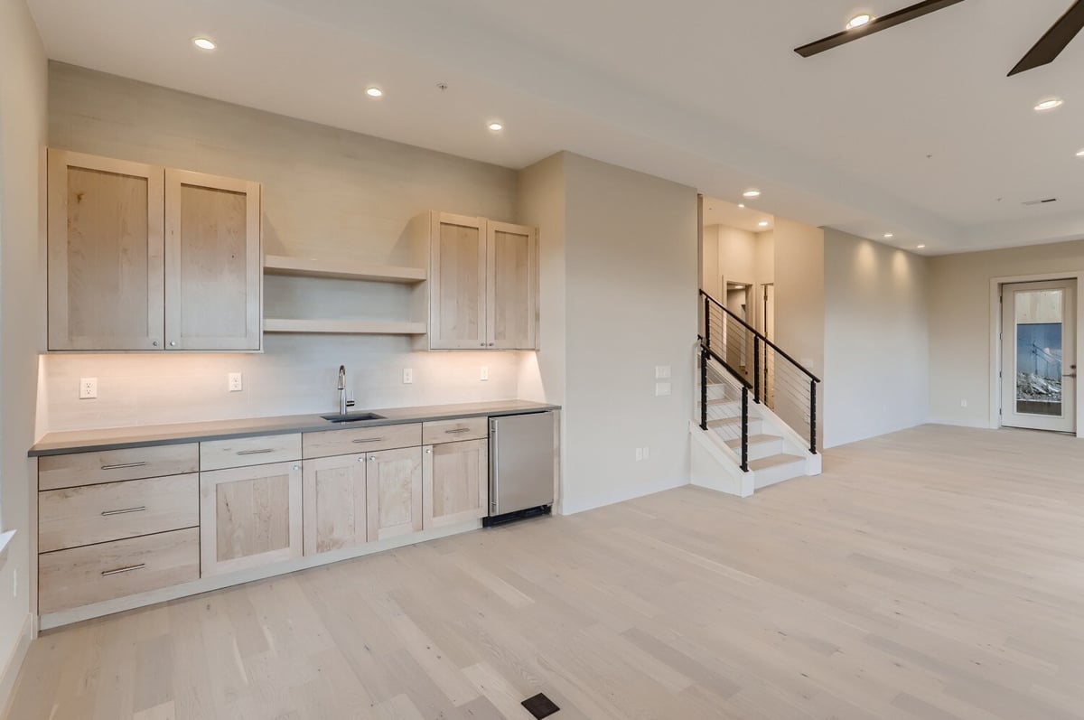 Lower level recreation room with ample space for activities in a Sheffield Homes custom home in Arvada, CO