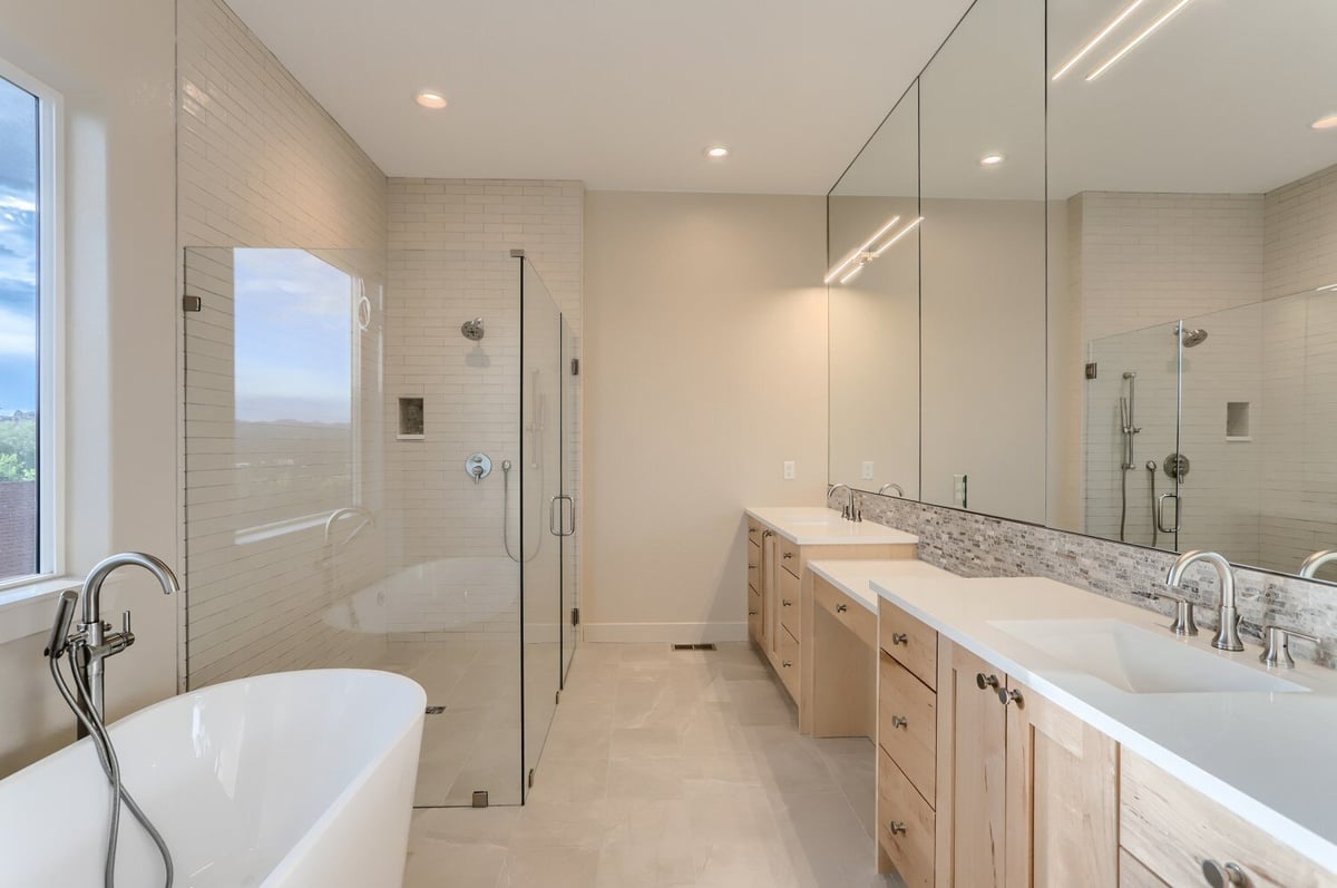 Luxurious primary bathroom with freestanding tub and dual vanities by Sheffield Homes in Arvada, CO