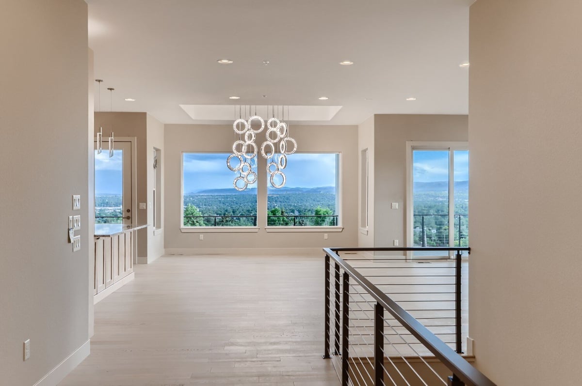 Modern stairway with sleek metal railing in a Sheffield Homes custom home in Arvada, CO