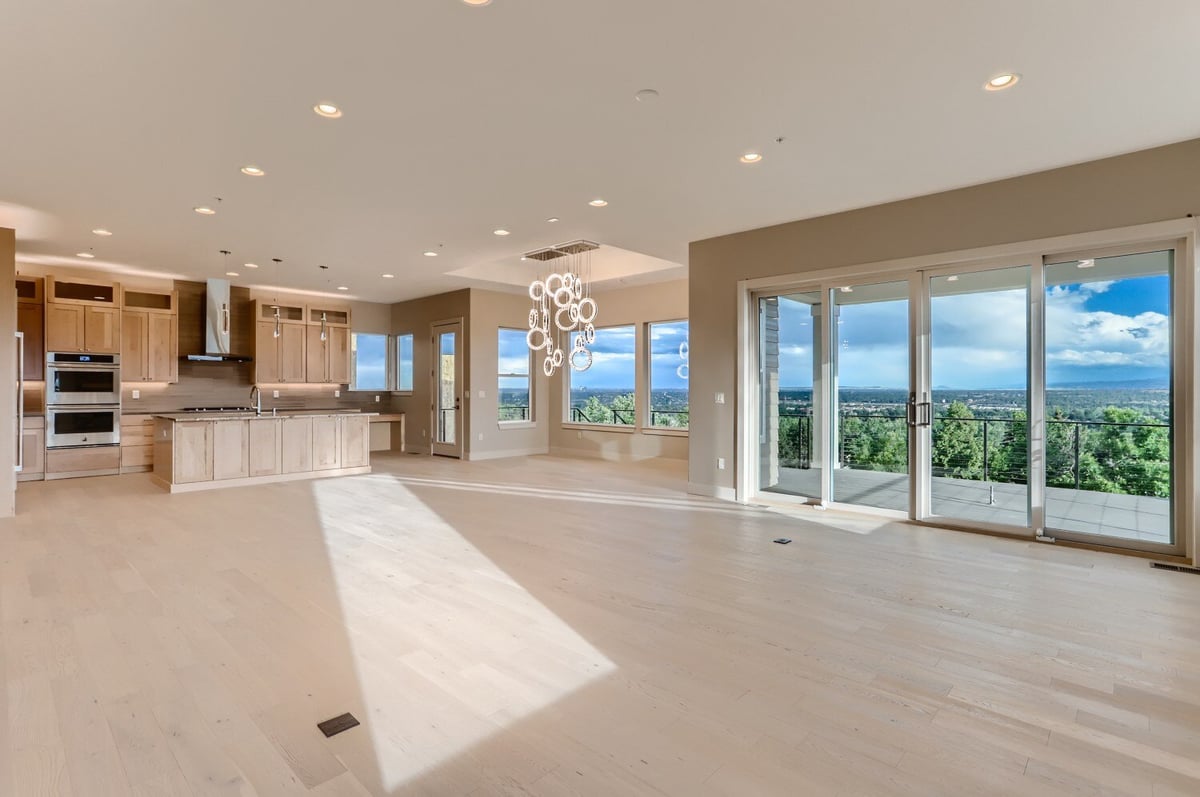 Open-concept living room with access to a large patio and stunning views by Sheffield Homes in Arvada, CO