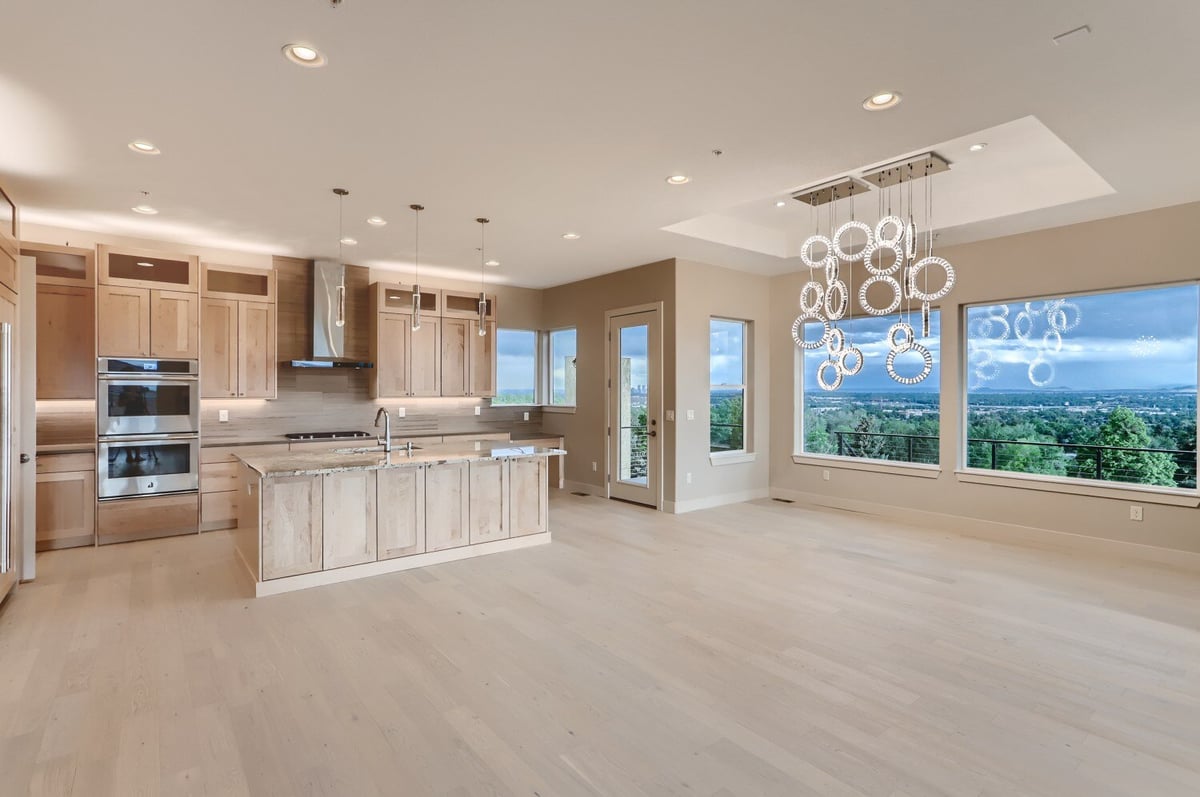 Spacious custom kitchen with natural wood cabinetry and modern lighting in a Sheffield Homes project in Arvada, CO