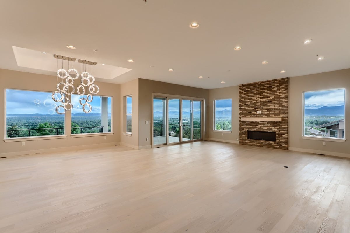 Spacious living room with large windows and scenic views in a custom home by Sheffield Homes in Arvada, CO