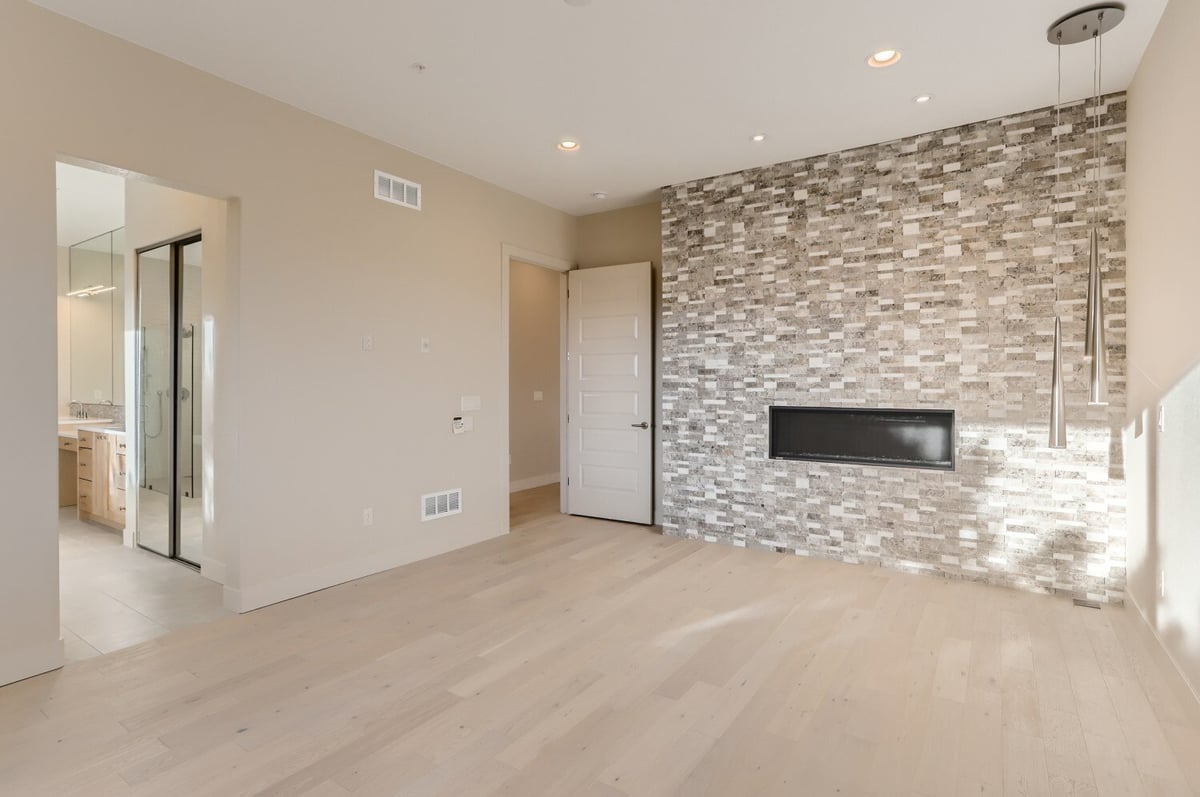 Spacious primary bedroom with natural light and mountain views in a custom home by Sheffield Homes in Arvada, CO