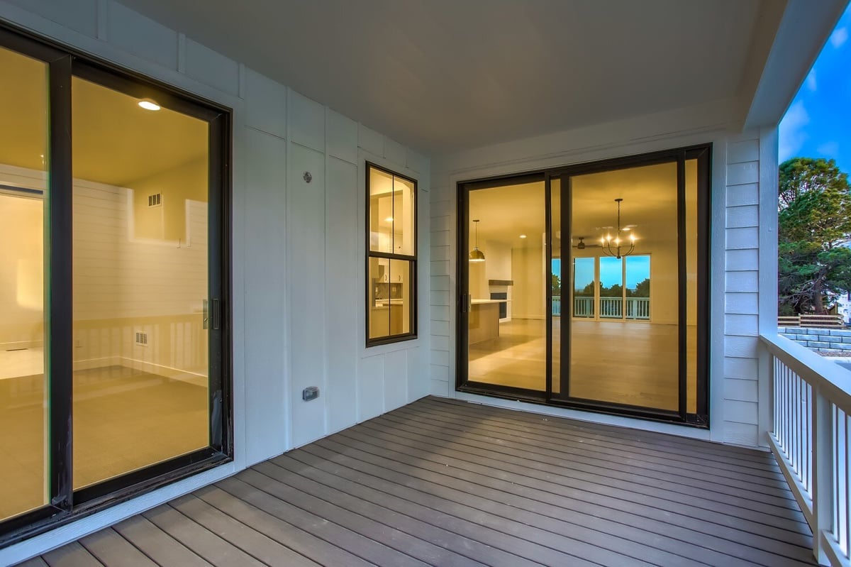 Balcony off the bedroom and living room with wood-like flooring in a custom home by Sheffield Homes in Arvada, CO