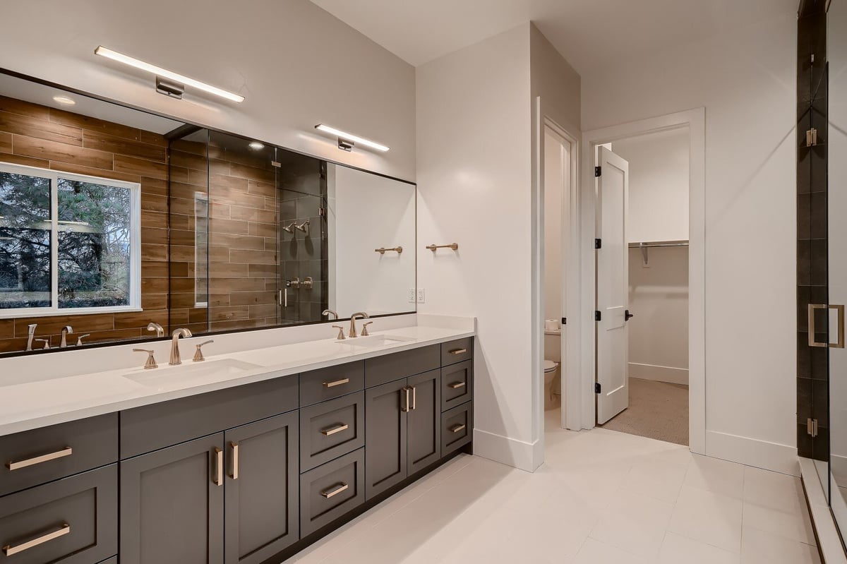 Full view of the primary bathroom with multiple vanities in a custom home by Sheffield Homes in Arvada, CO