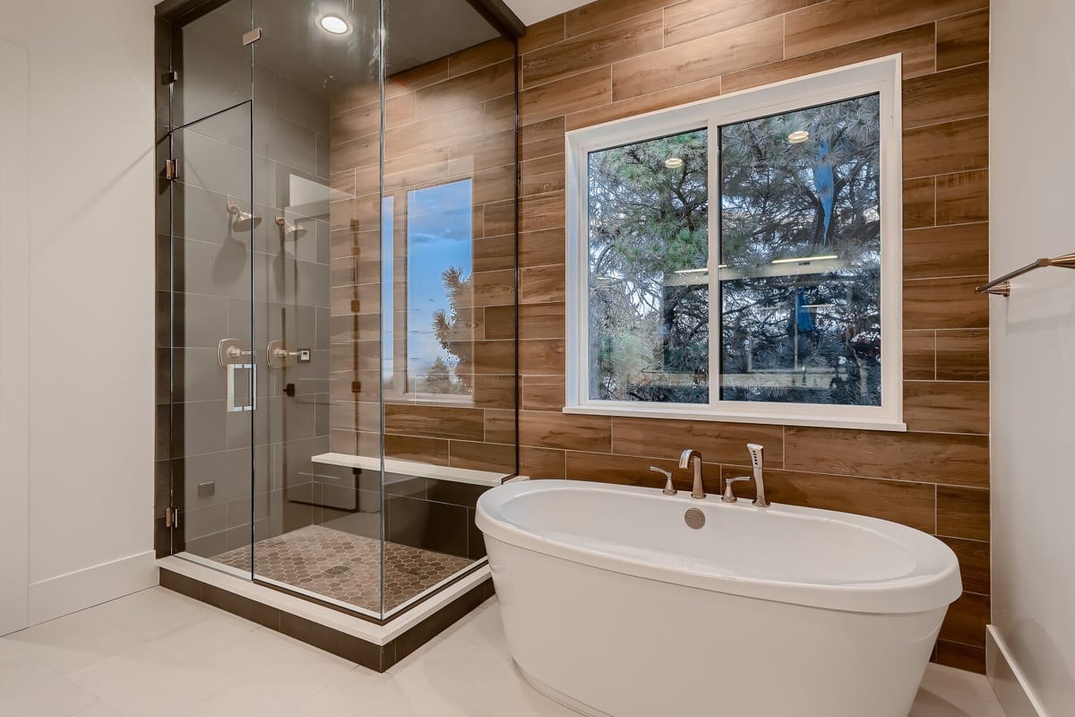 Premium primary bathroom with a shower room and bathtub in a custom home by Sheffield Homes in Arvada, CO