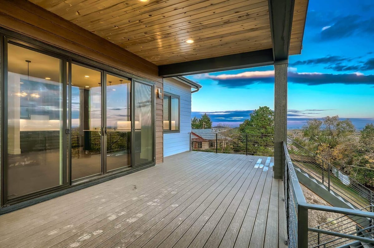 Side view of the deck with scenic mountain and greenery views in a custom home by Sheffield Homes in Arvada, CO