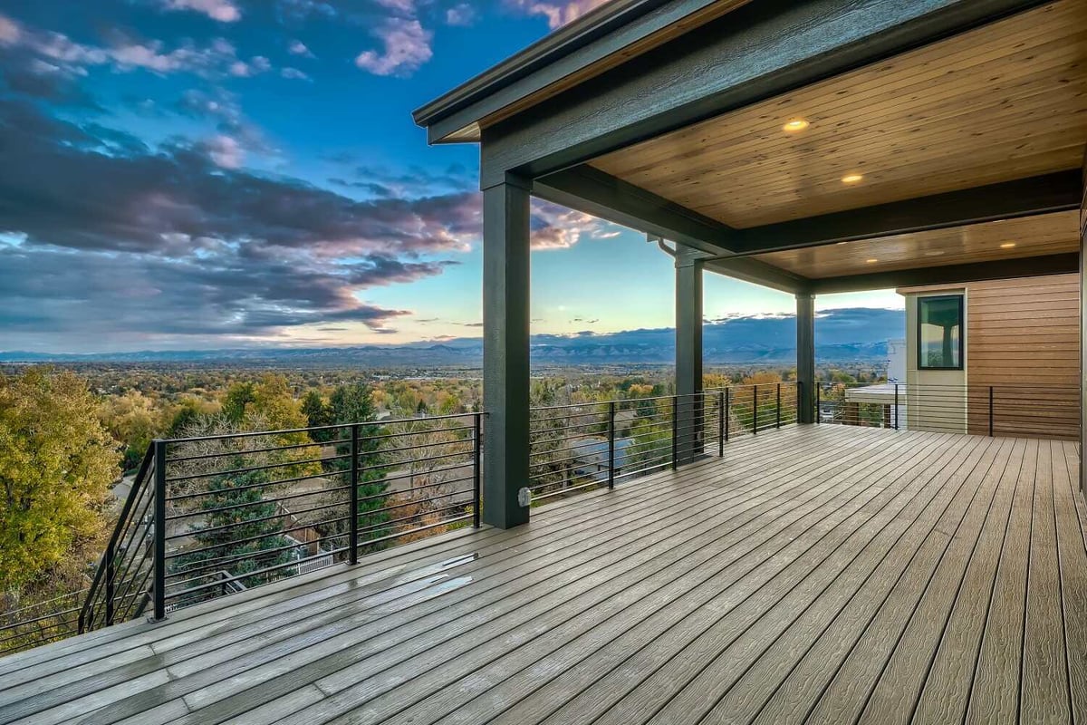 Spacious deck with scenic mountain and greenery views in a custom home by Sheffield Homes in Arvada, CO