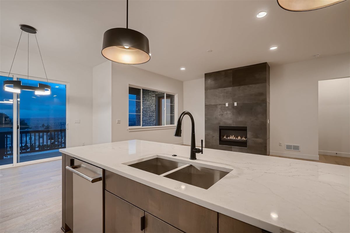 Focused view of a modern kitchen island with wooden and metal cabinets in the base by Sheffield Homes in Arvada, CO