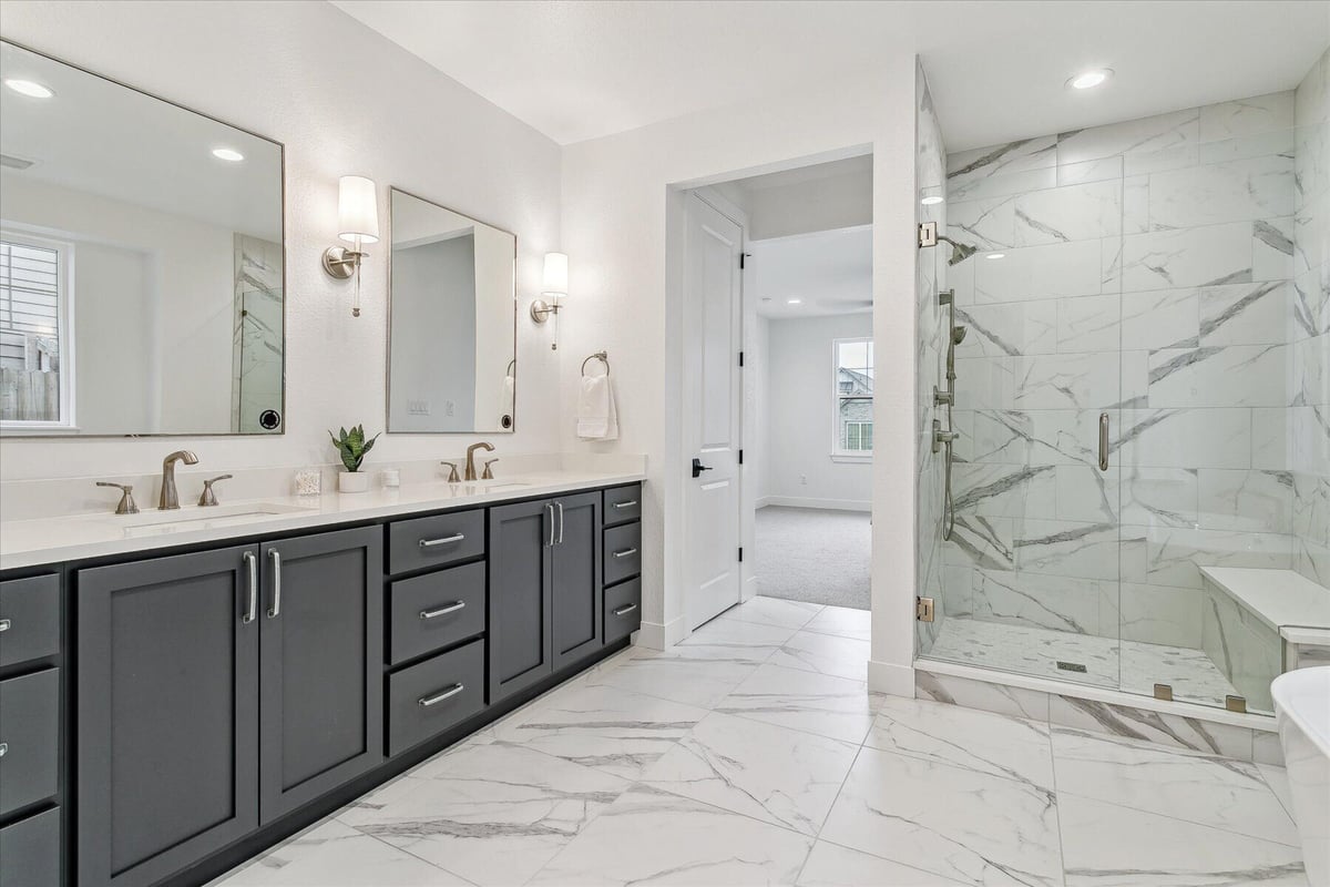 Bathroom with stylish dual vanities and a shower enclosure in a custom home by Sheffield Homes in Arvada, CO