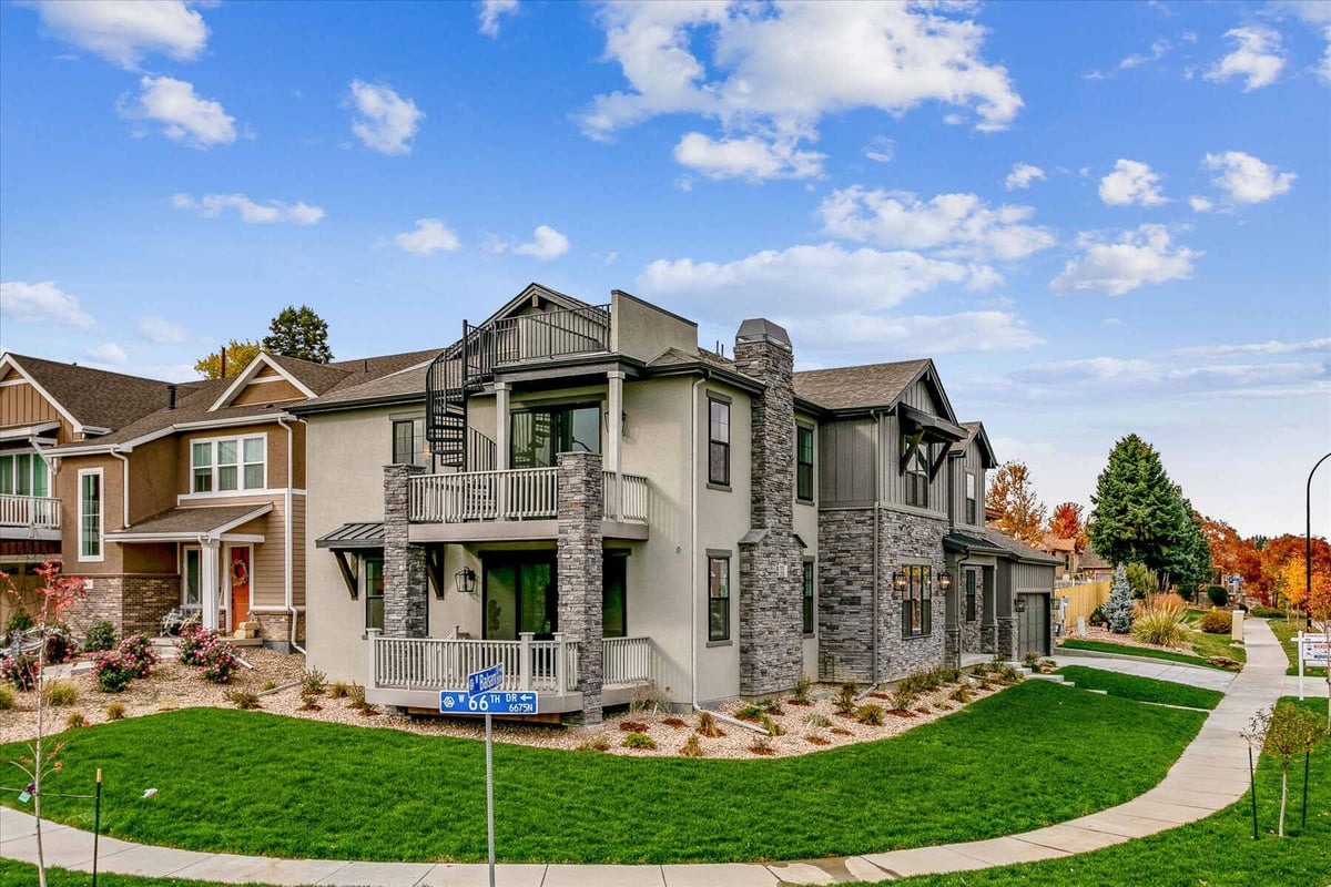 Exterior side view of a large custom home with a lawn, built by Sheffield Homes in Arvada, CO