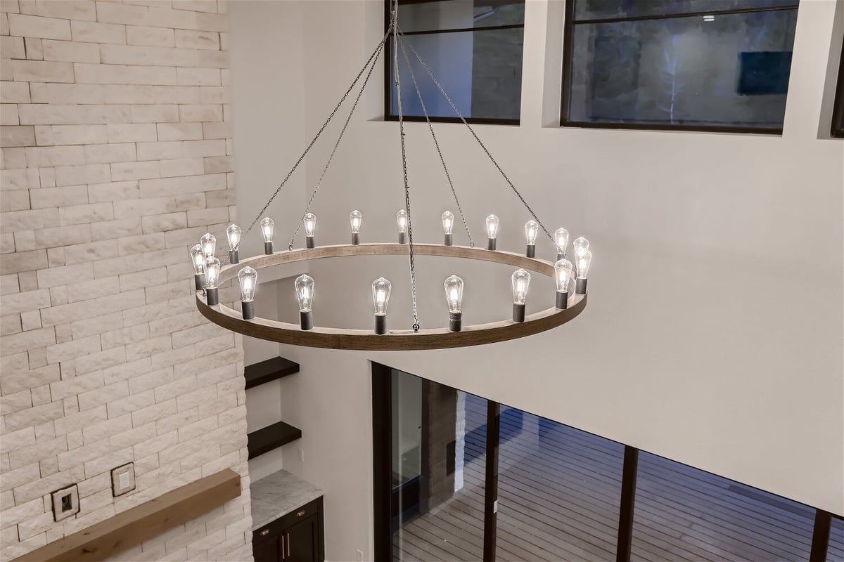 Chandelier with bulb lighting, detailed view from the second floor in a custom home by Sheffield Homes in Evergreen, CO