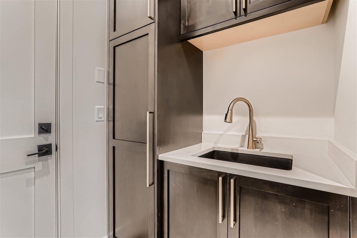 Closeup of a mudroom detail with stainless steel appliances and a sink in a custom home by Sheffield Homes in Evergreen, CO