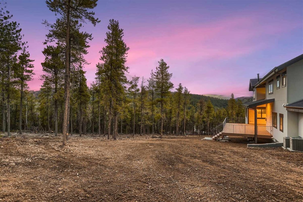 Rear exterior view of a large backyard outside a custom home built by Sheffield Homes in Evergreen, CO