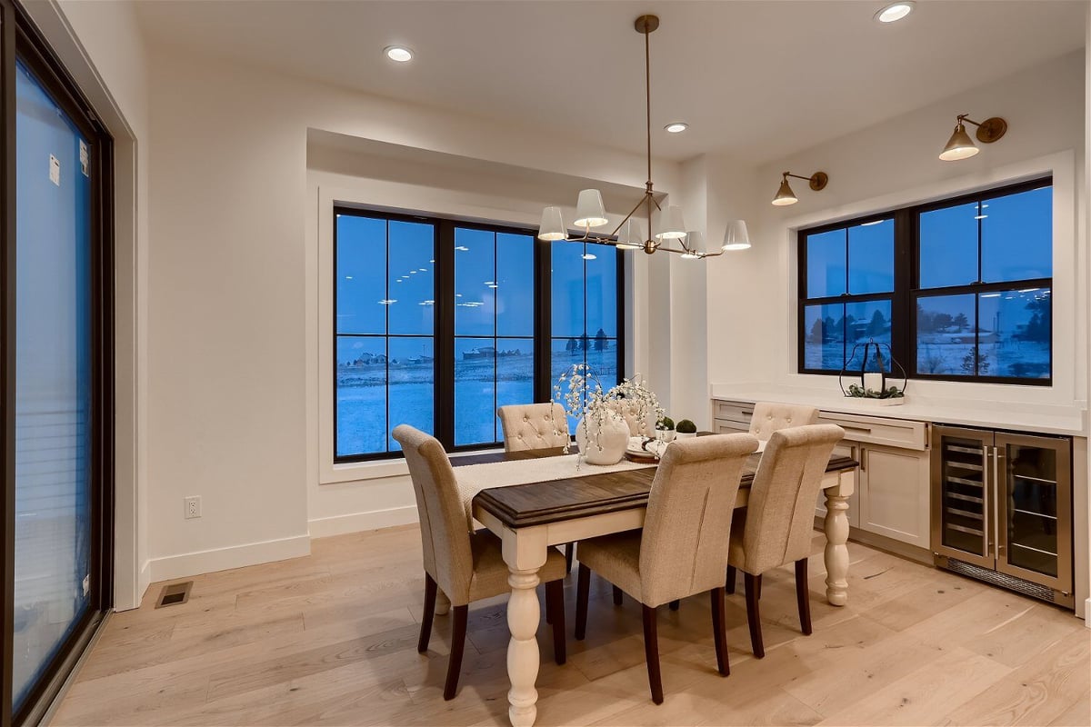 Elegant dining room with a fine dining table and chairs in a custom home by Sheffield Homes in Franktown, CO