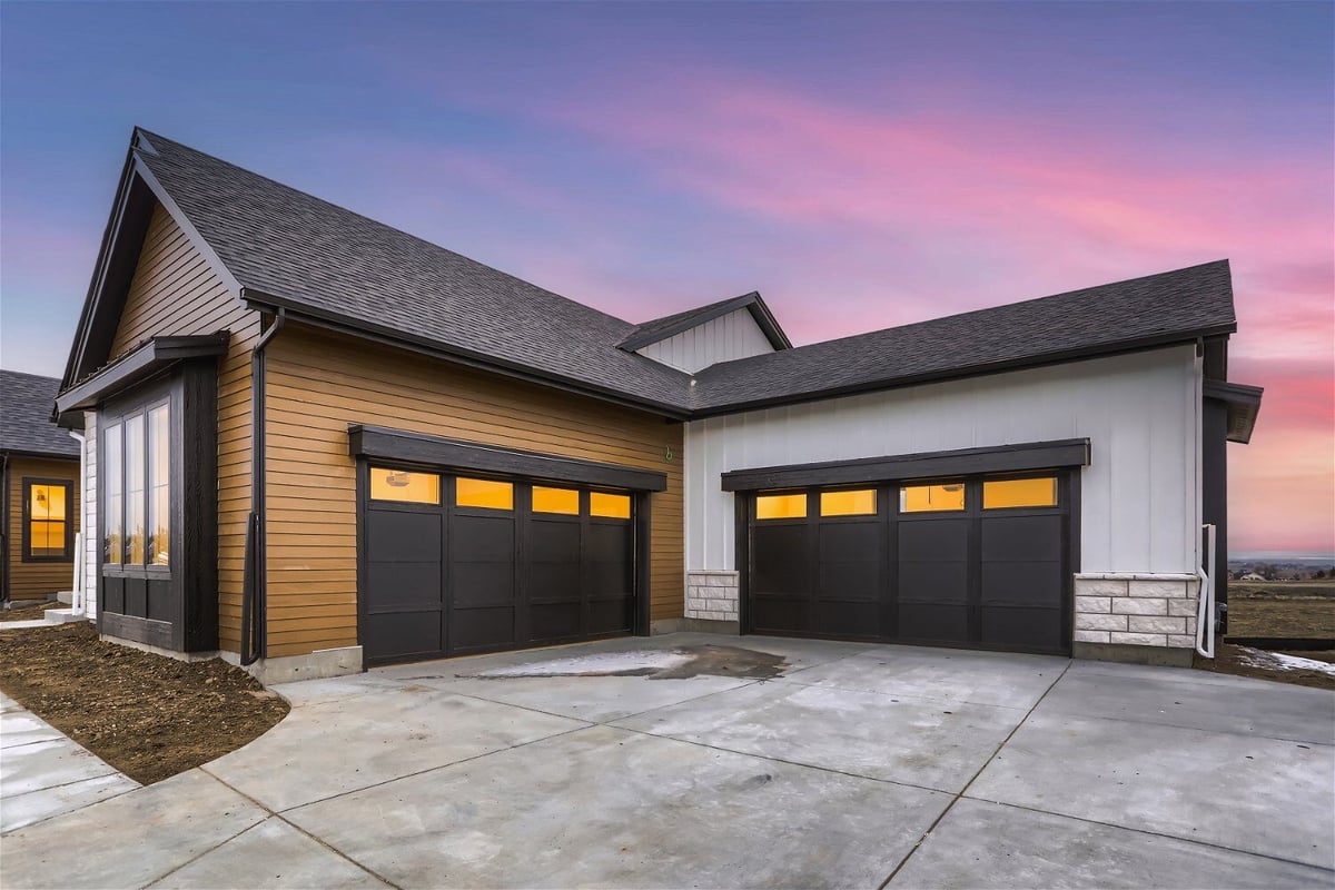 Exterior front view of the garage next to a beautiful custom home built by Sheffield Homes in Franktown, CO