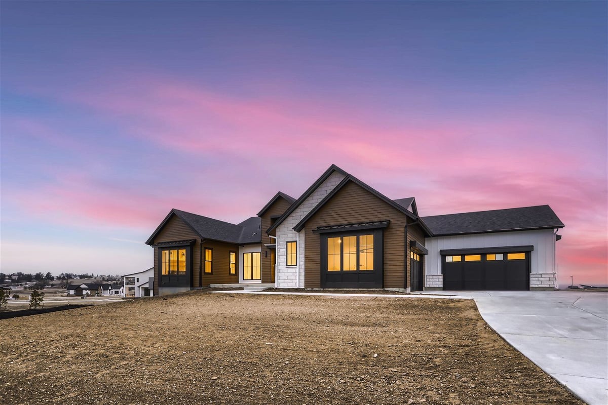 Low-angle front exterior shot of a custom home with a garage and front yard, built by Sheffield Homes in Franktown, CO