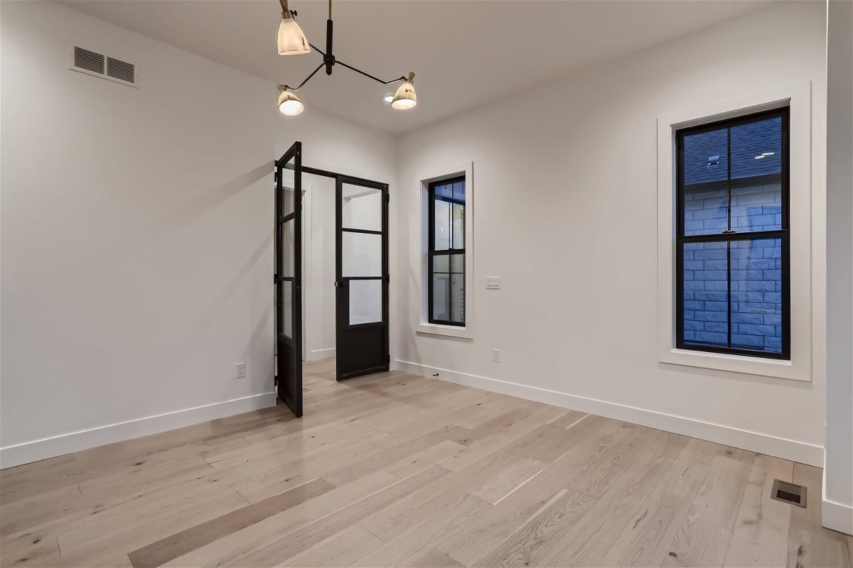 Office space in a custom home featuring access door and sliding windows, built by Sheffield Homes in Franktown, CO