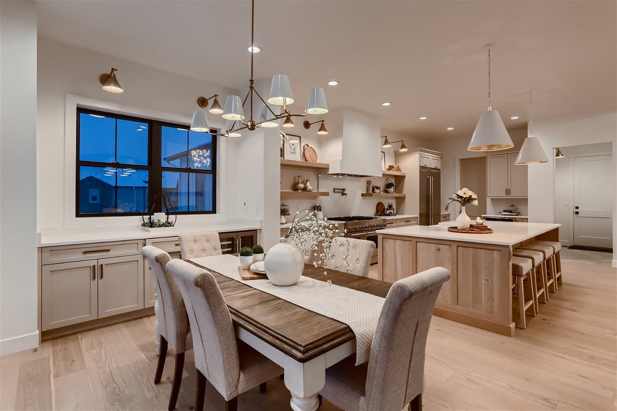 Spacious family dining room with two fine dining tables and chairs in a custom home by Sheffield Homes in Franktown, CO