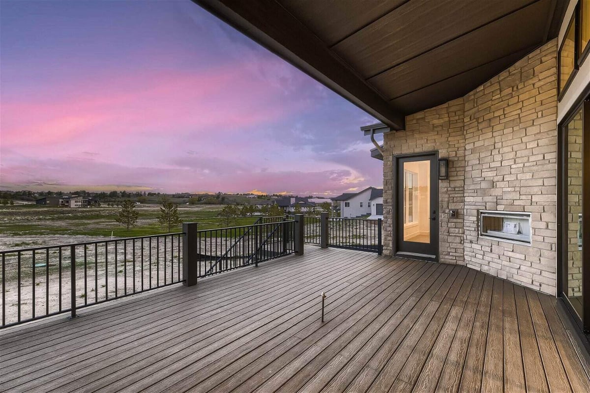 Custom deck with a black metal fence offering beautiful views from a home by Sheffield Homes in Franktown, CO