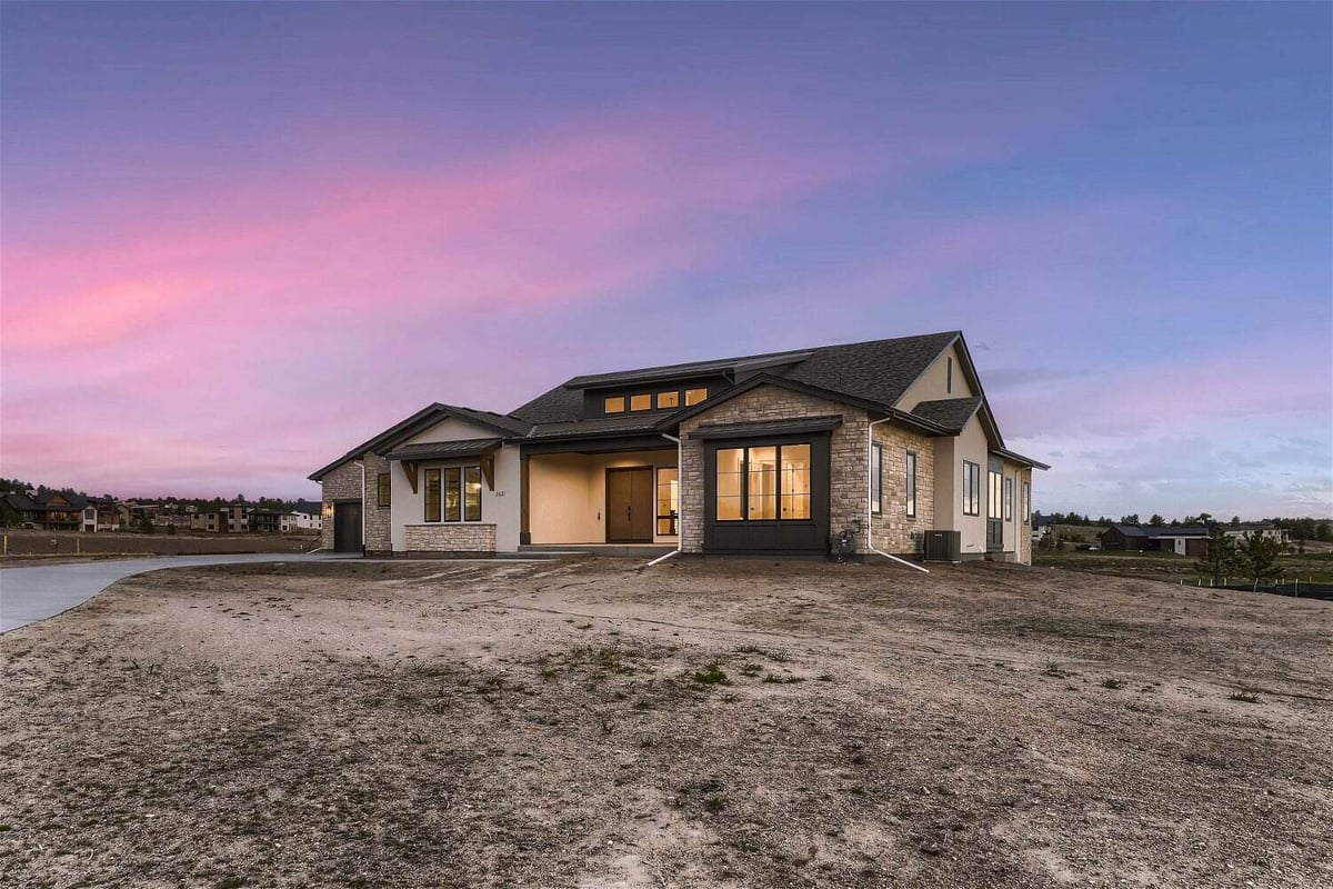 Exterior front view of a large custom home with a big front yard built by Sheffield Homes in Franktown, CO
