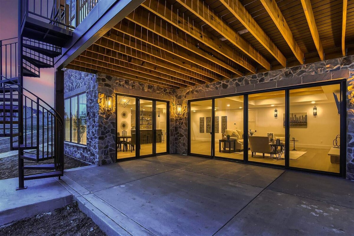 Custom patio off the living room with large sliding doors in a home by Sheffield Homes in Franktown, CO