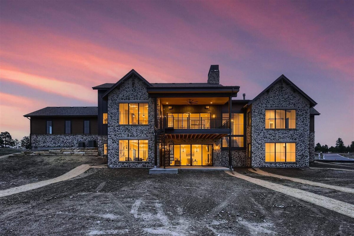 Exterior rear view of a custom home with a backyard in Franktown, CO, built by Sheffield Homes