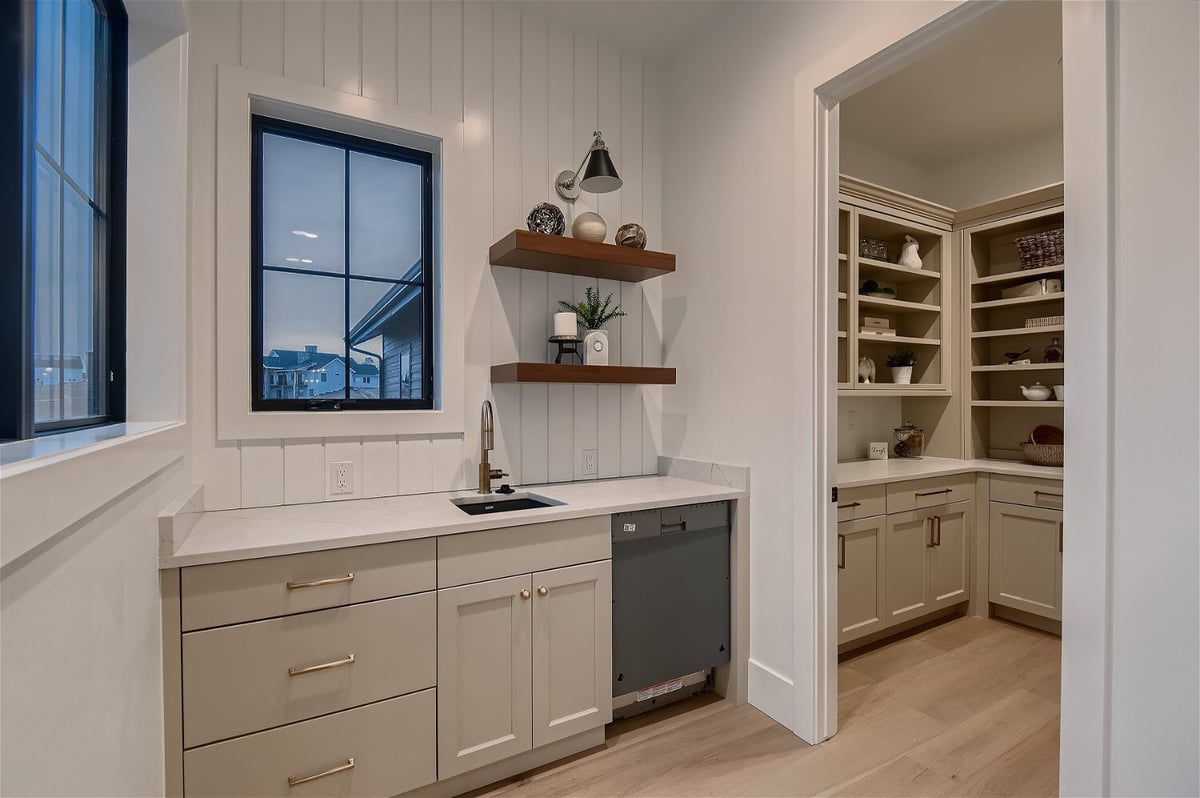 Modern butler_s pantry for kitchen and house cleaning storage in a custom home by Sheffield Homes in Franktown, CO