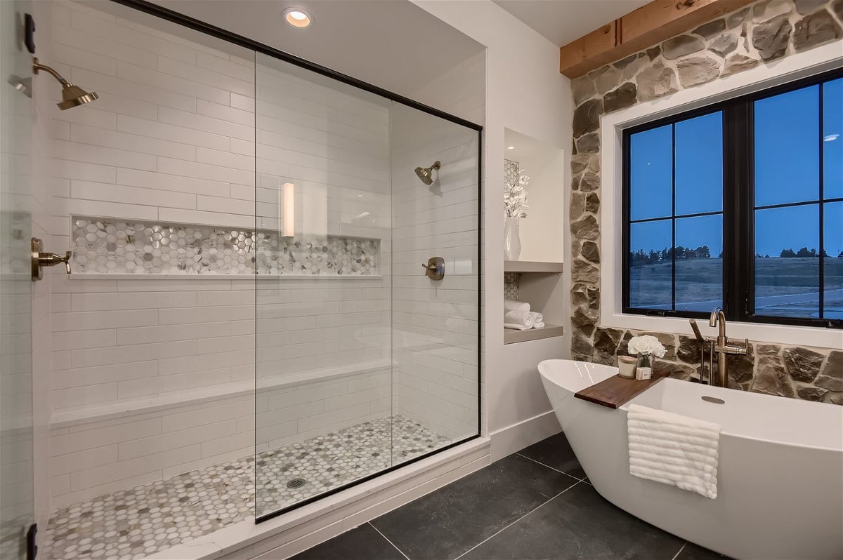 Premium primary bathroom with a shower enclosure and fancy bathtub in a custom home by Sheffield Homes in Franktown, CO