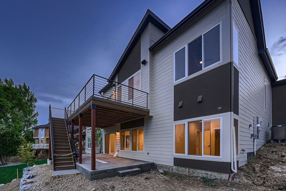 Backyard with landscaped rock border and steps in a custom Denver home by Sheffield Homes