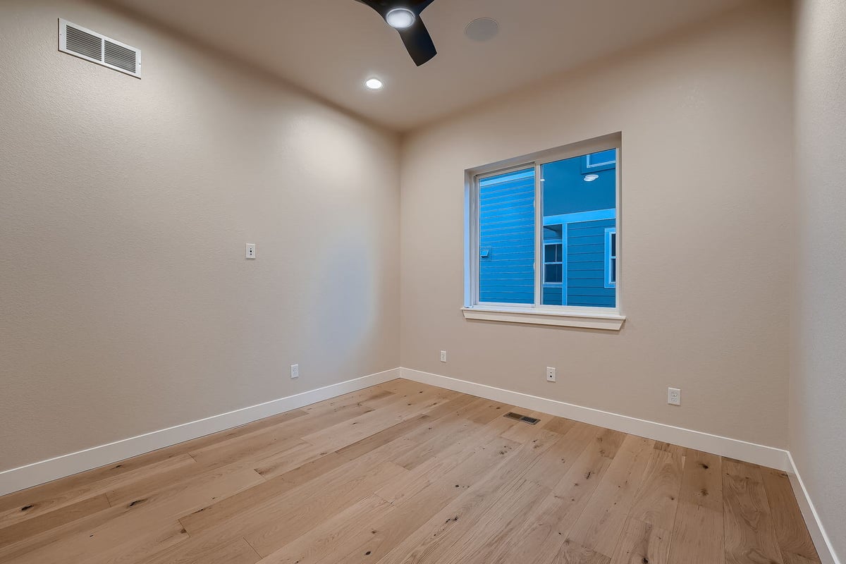 Bedroom with ceiling fan and natural light in a custom Denver home by Sheffield Homes