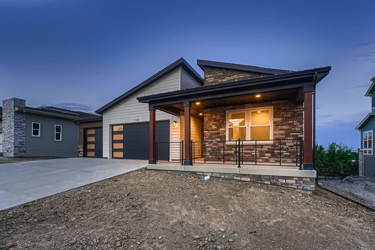 Custom home exterior in Denver, CO by Sheffield Homes, featuring a dual garage and inviting porch