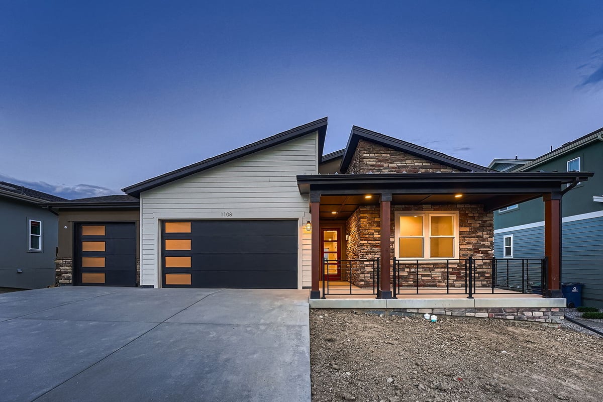 Front exterior of a custom-built home by Sheffield Homes in Denver, CO, showcasing a modern facade with dual garages