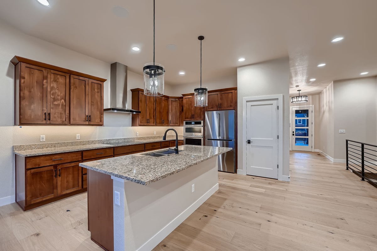 Kitchen with granite countertops and pendant lighting in a Sheffield Homes custom home, Denver, CO