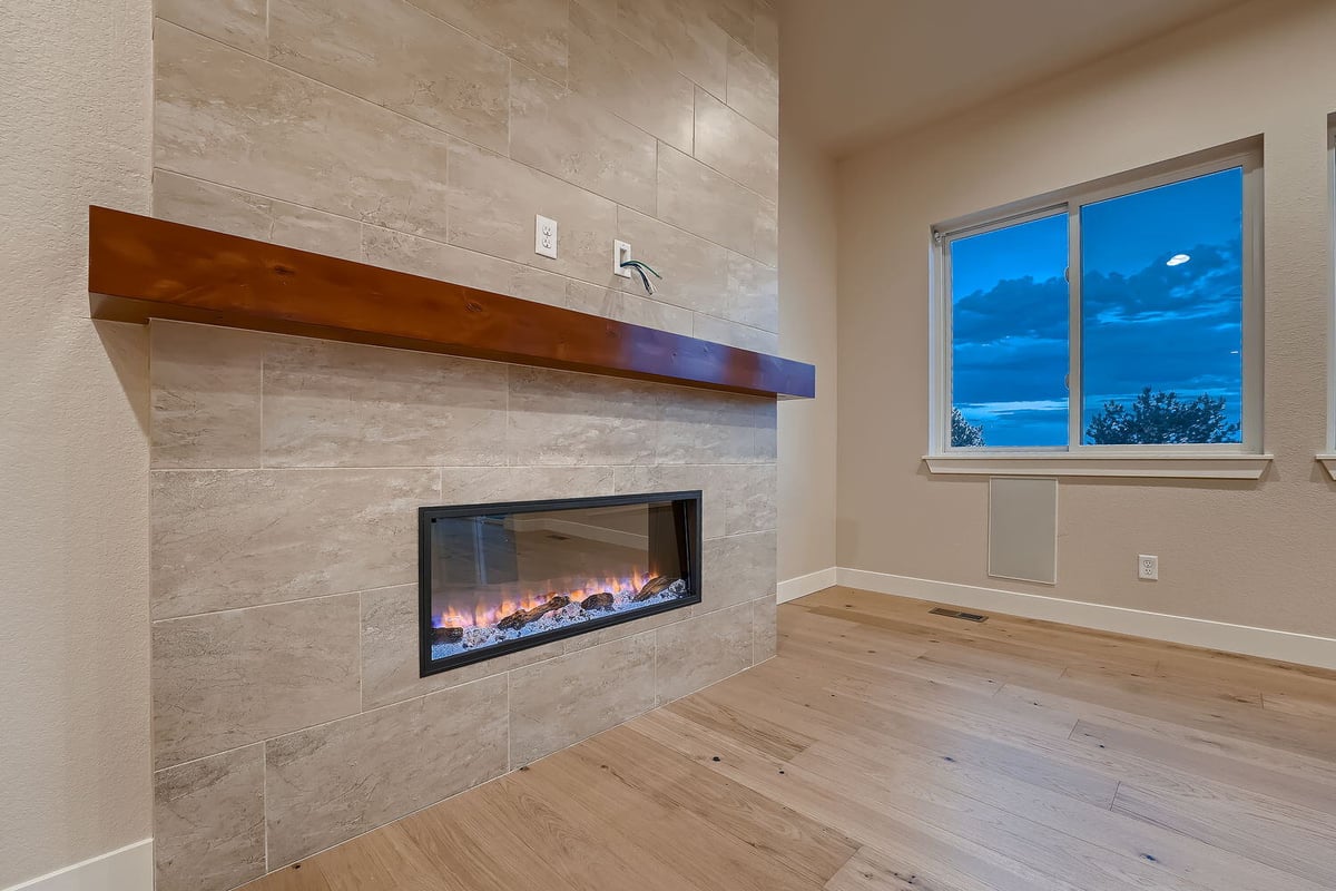 Living room with expansive views and elegant fireplace, custom-built by Sheffield Homes, Denver, CO