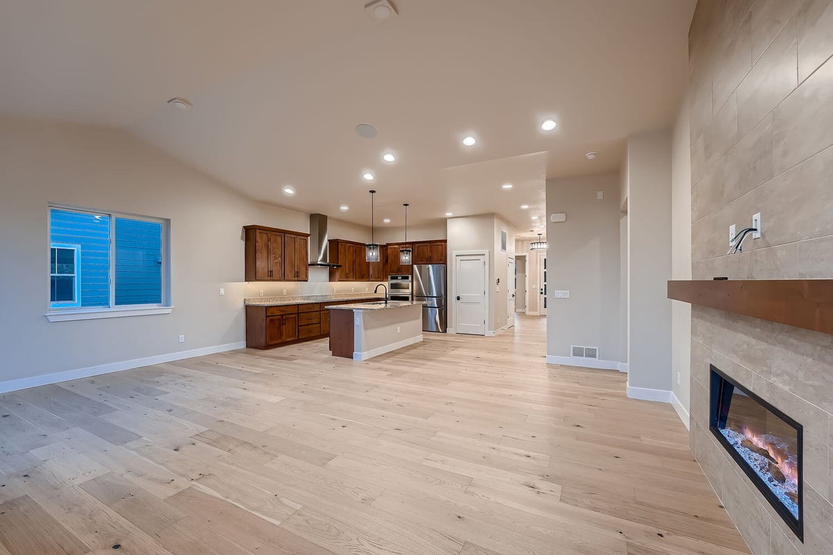 Open living room with fireplace in a custom home by Sheffield Homes, Denver, CO