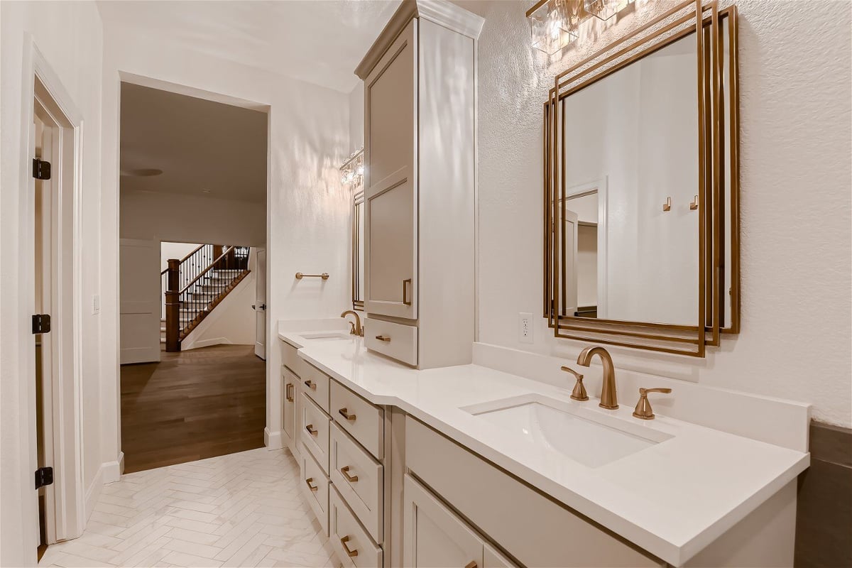 Bathroom with modern dual vanities accessible from the living room in a custom home by Sheffield Homes in Louisville, CO